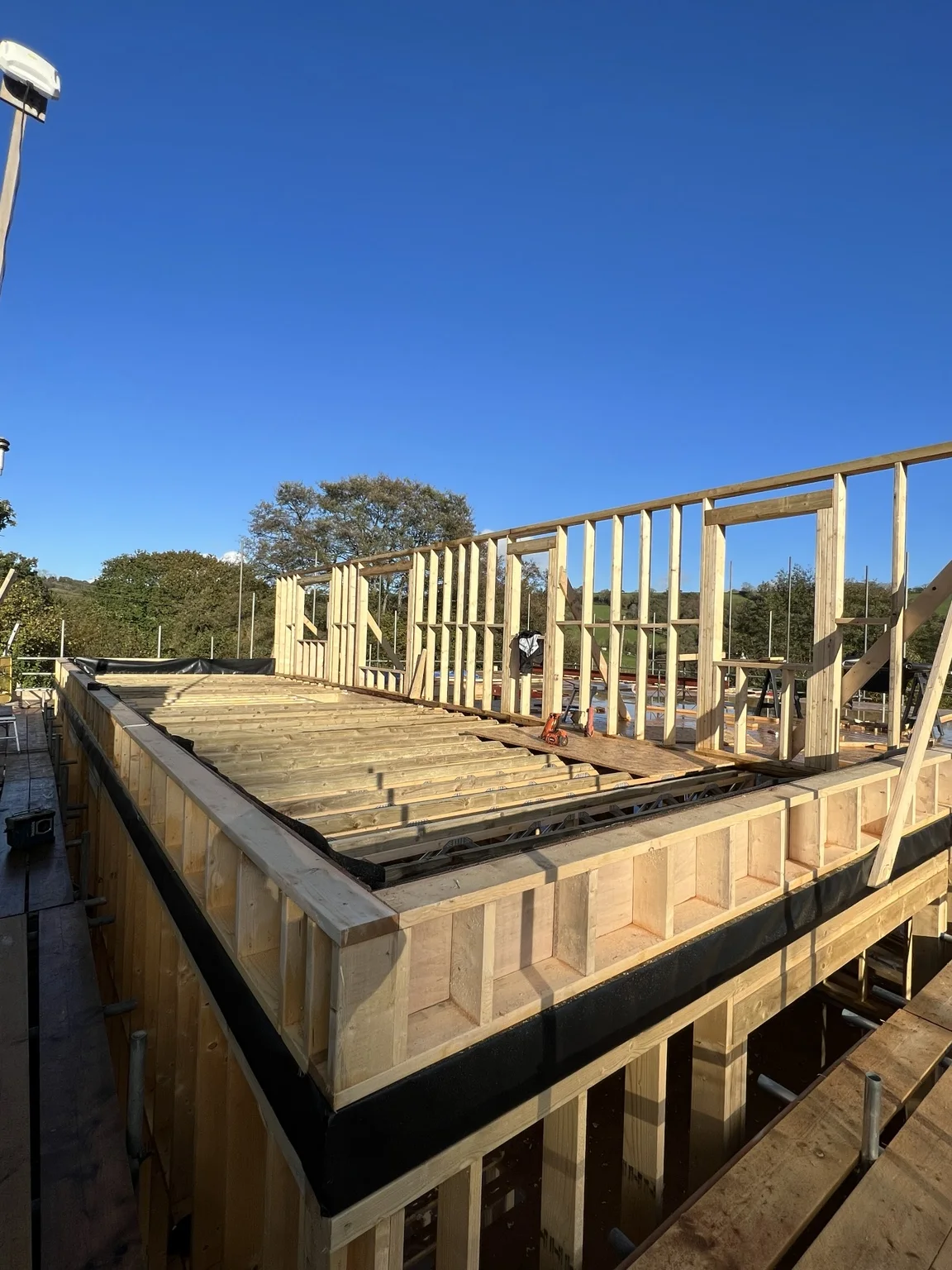 Upper-storey timber framing and floor joists on a bespoke build