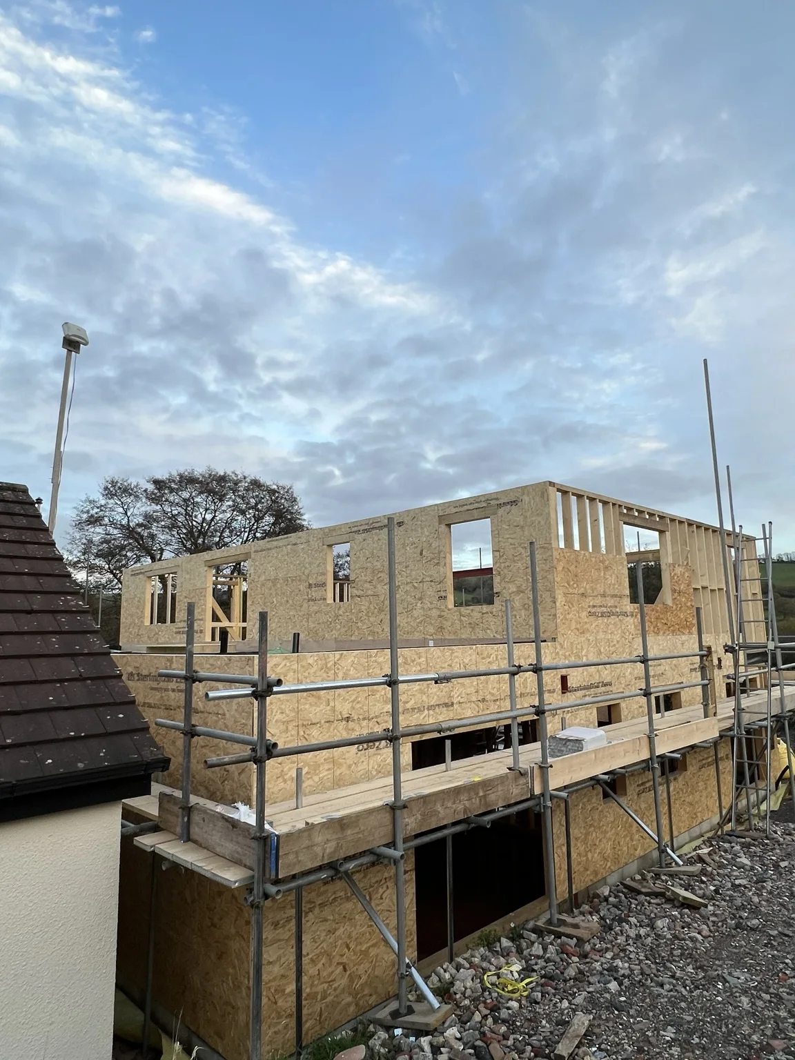 Sheathed timber frame building under construction